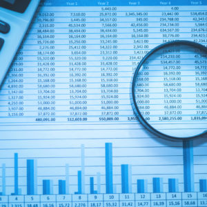 Spreadsheet bank accounts accounting with calculator and magnifying glass.